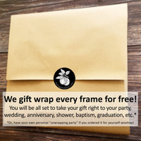 a brown envelope with a sticker saying, we gift wrap every frame for free